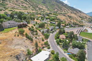 Aerial overview of property's location featuring a mountain backdrop and nearby suburban area