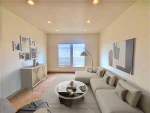 Living room with carpet flooring and recessed lighting  Virtually staged