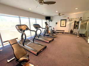 Gym with ceiling fan and recessed lighting