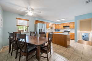 Dining room featuring a ceiling fan and light tile patterned floors