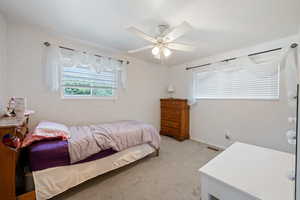 Bedroom featuring light carpet and ceiling fan