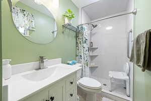 Full bathroom with vanity and tiled shower