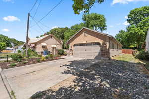 View of front facade with driveway and a garage