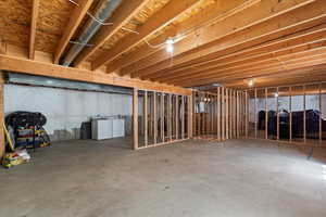 Unfinished below grade area with washer and dryer