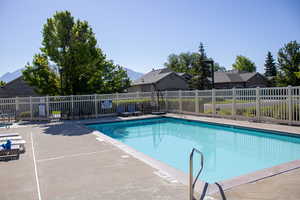 Community pool with a patio and a mountain view