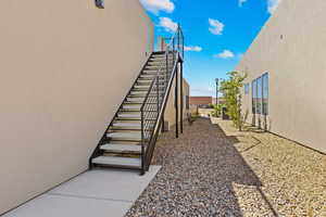 View of home's exterior with stucco siding and stairs