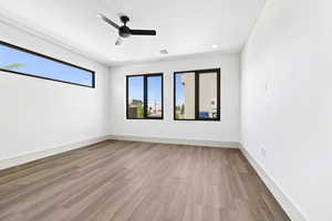Unfurnished room featuring wood finished floors, ceiling fan, and recessed lighting