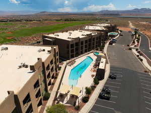 Aerial view of a mountain backdrop and a golf course