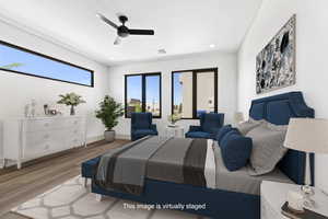 Bedroom with wood finished floors, recessed lighting, and a ceiling fan