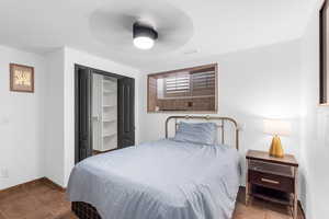 Bedroom featuring tile patterned flooring and ceiling fan