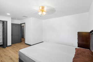 Bedroom with light wood finished floors and baseboards
