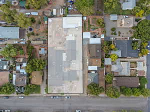 Aerial view of property and surrounding area featuring nearby suburban area
