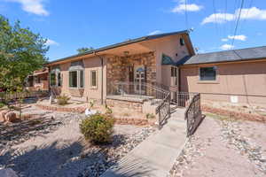 View of front of property featuring stucco siding and stone siding