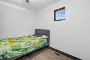 Bedroom with wood finished floors and a ceiling fan