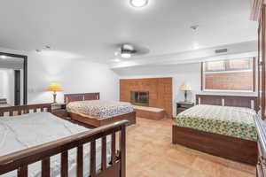 Bedroom with recessed lighting and a brick fireplace