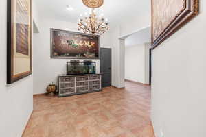 Living room with a chandelier and baseboards