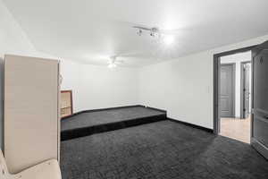 Unfurnished room with light carpet and a ceiling fan