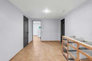 Hall featuring washer / clothes dryer and an upstairs landing