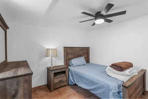 Bedroom with a ceiling fan and baseboards