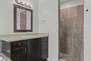 Full bathroom featuring vanity and a tile shower