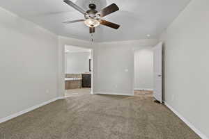 Unfurnished room featuring ceiling fan and light carpet
