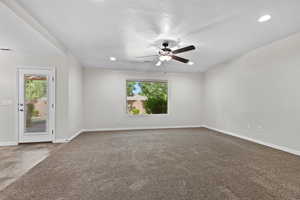 Empty room with healthy amount of natural light, a ceiling fan, recessed lighting, and carpet