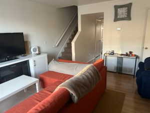 Living area featuring wood finished floors and stairway