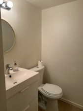Half bathroom with vanity and toilet