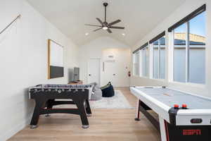Game room featuring a ceiling fan, vaulted ceiling, light wood finished floors, and recessed lighting