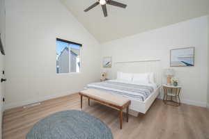Bedroom featuring wood finished floors, high vaulted ceiling, and ceiling fan
