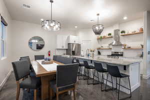 Dining room featuring a chandelier and recessed lighting