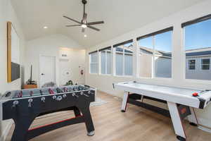 Playroom featuring light wood finished floors, a ceiling fan, lofted ceiling, and recessed lighting