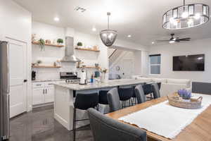 Dining room with a chandelier, recessed lighting, and a ceiling fan