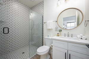 Bathroom featuring vanity and a tile shower