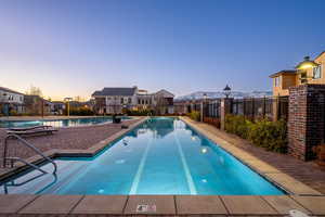 Community pool featuring a mountain view and a patio area