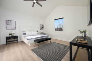 Bedroom featuring light wood-style flooring, high vaulted ceiling, and ceiling fan