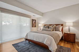 Bedroom featuring wood finished floors and baseboards