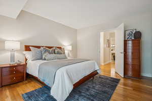 Large bedroom featuring light wood-style flooring and baseboards