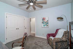 Carpeted bedroom 3 featuring a ceiling fan and baseboards