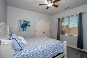 Bedroom 2 with carpet flooring, ceiling fan, and a closet