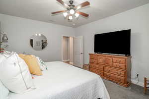 Primary bedroom with carpet and ceiling fan