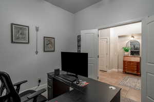Office area featuring light tile patterned floors and baseboards
