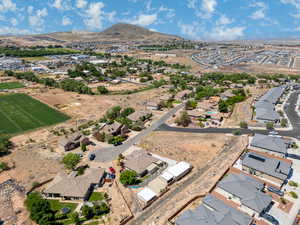 Aerial view of property's location featuring a mountain backdrop and nearby suburban area
