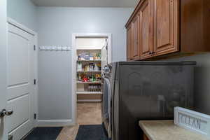 Washroom featuring cabinet space and separate washer and dryer