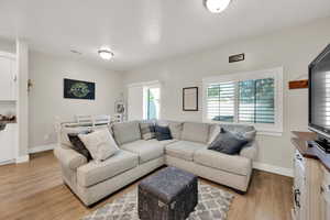 Living area featuring light wood-style floors and baseboards