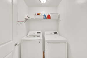 Laundry room featuring separate washer and dryer