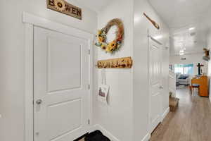 Corridor featuring light wood-type flooring