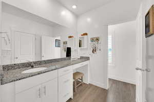 Bathroom featuring wood finished floors and vanity