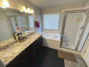 Main Full bathroom with a garden tub, a stall shower, and double vanity