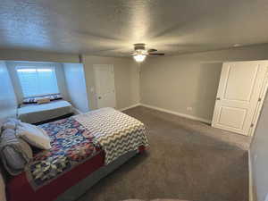 Bedroom #3 featuring dark carpet, a textured ceiling, and ceiling fan